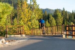 Man biking in Lake Tahoe on a paved trail