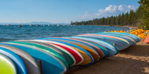 Olympic Village Inn paddleboards on the beach in Lake Tahoe